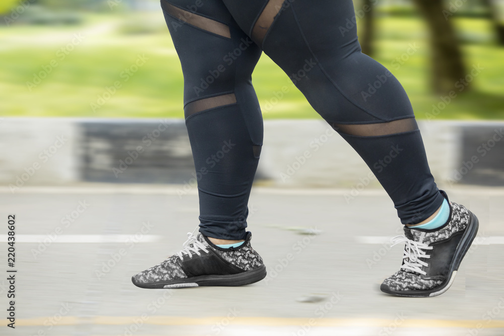 Fat woman feet running on the road