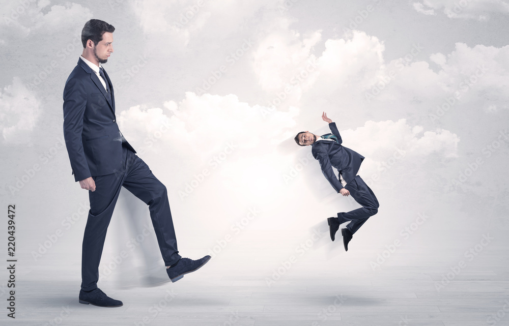 Big businessmen kicking himself as a small employee with cloudy background
Big businessmen kicking himself as a small employee with cloudy background