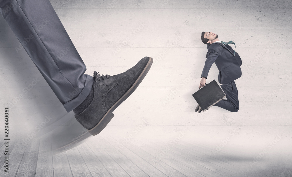Big foot in a black shoe fire small, young, businessman who is flying away in the space
Big foot in a black shoe fire small, young, businessman who is flying away in the space