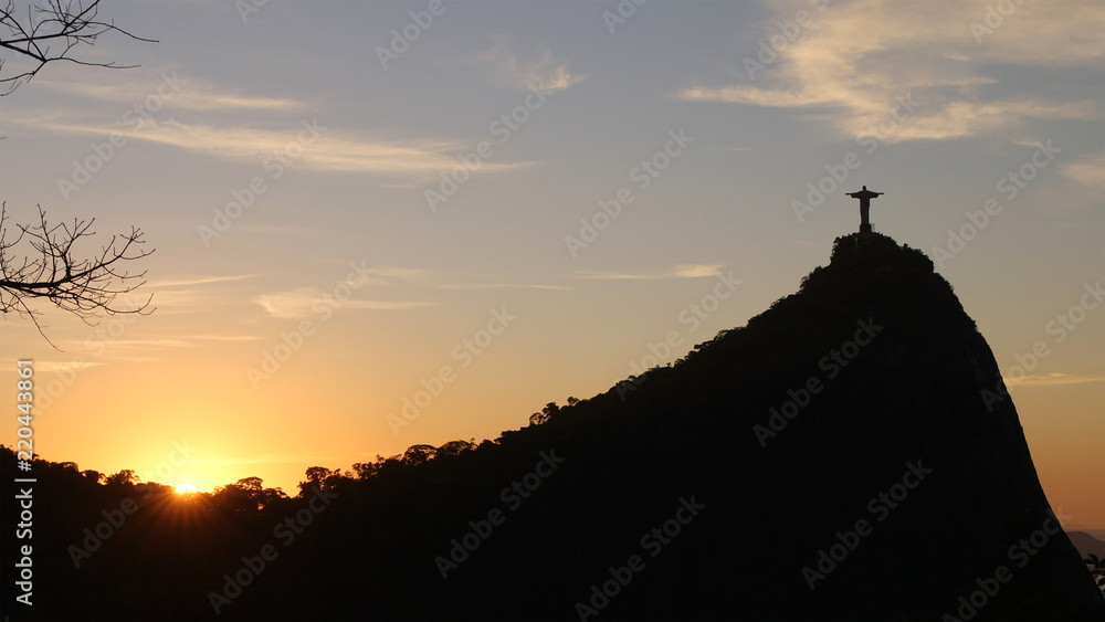 Fototapeta premium Christ the Redeemer statue on top of Corcovado, Rio de Janeiro, Brazil on sunset.