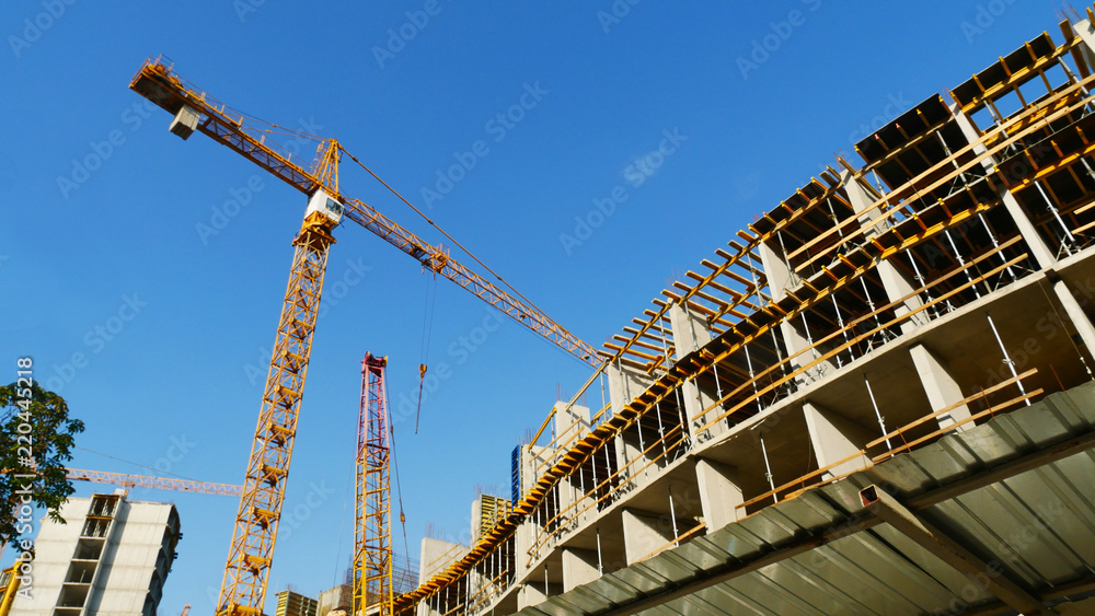 Construction site. Crane near concrete building. Construction site. Crane near concrete building.