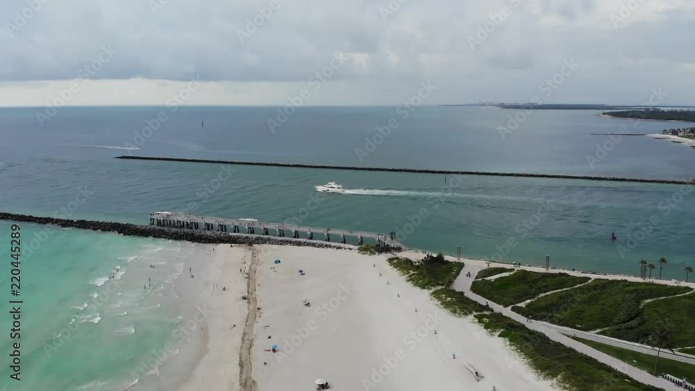 Aerial view over South beach heading South towards the shipping lane with a fishing boat heading out to sea. Aerial view over South beach heading South towards the shipping lane with a fishing boat heading out to sea.