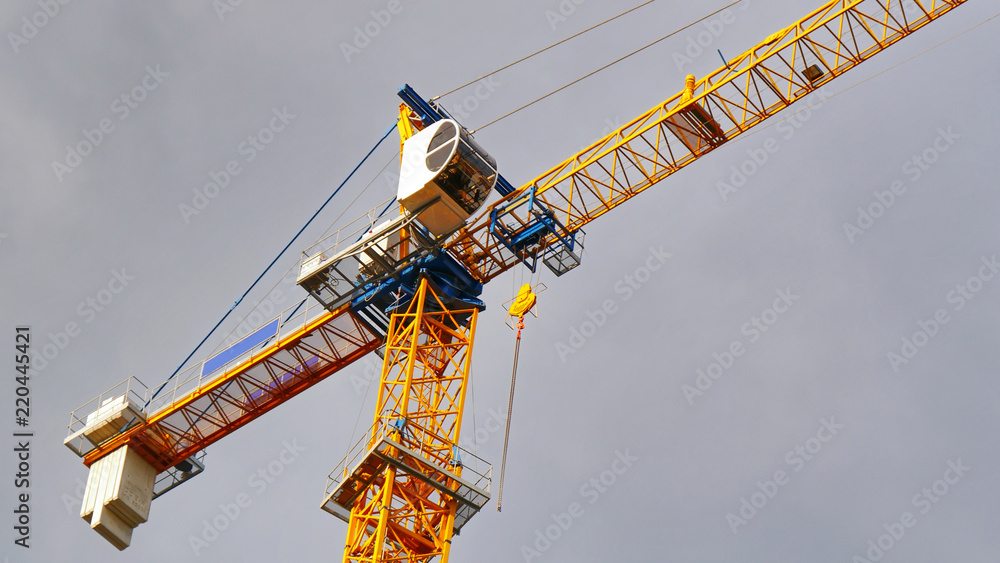 Huge crane against cloudy sky. Construction site. Huge crane against cloudy sky. Construction site.