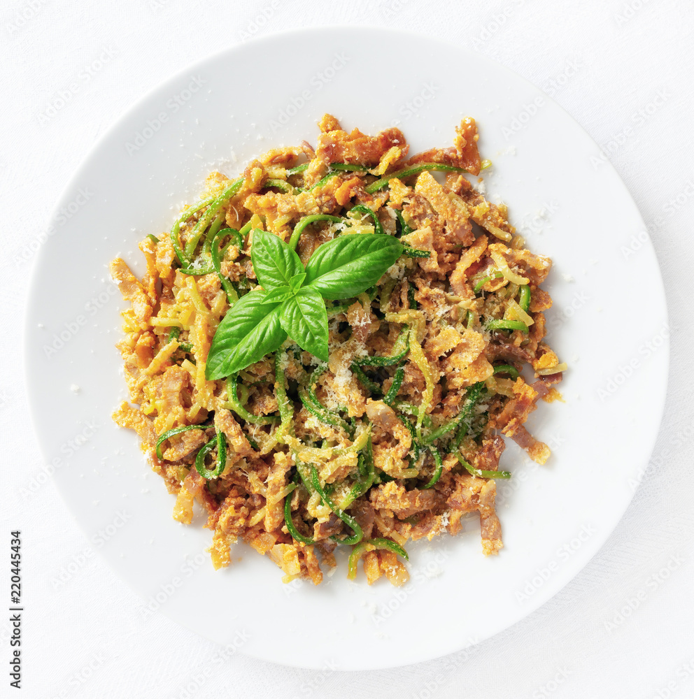 zucchini pasta with carbonara sauce decorated with basil leafs zucchini pasta with carbonara sauce decorated with basil leafs