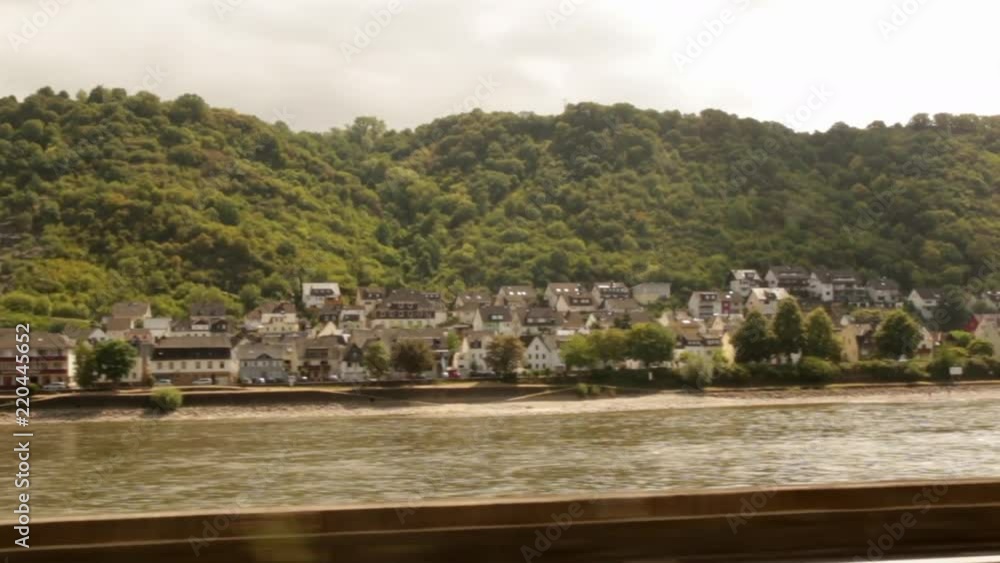 Slow motion of Driving through the german country side in the summer with a river and beautiful hillside and village passing by. Slow motion of Driving through the german country side in the summer with a river and beautiful hillside and village passing by.