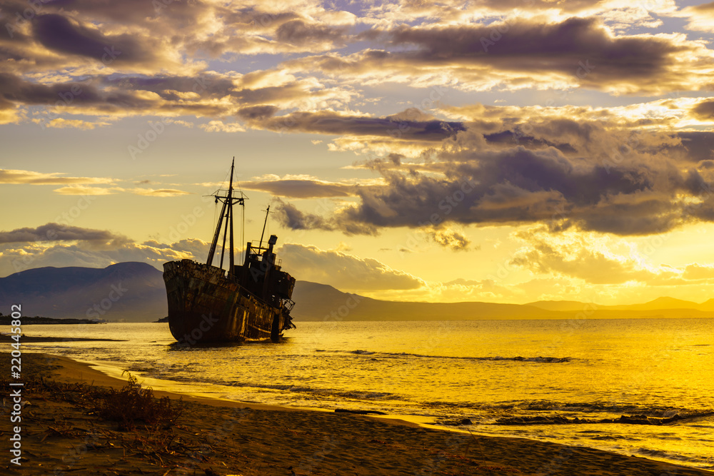 Rusty broken shipwreck on sea shore Rusty broken shipwreck on sea shore