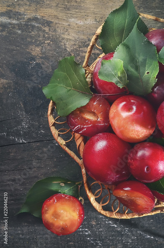 red plums in a wicker dishes