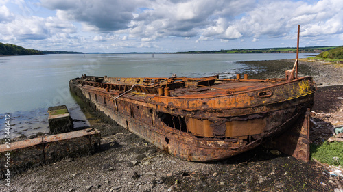 Old rusty abandoned shipping Barge On The River Shannon in the Republic of Ireland