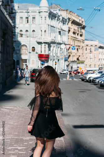 beautiful brunette whirls , dances on a street in the middle of the city, laughs, smiles, happiness,fun © Skripnik Olga