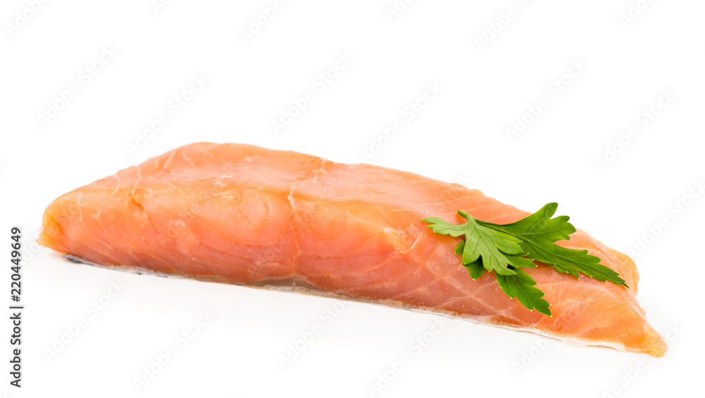 A piece of fresh salmon fish decorated with parsley leaf close-up on a white. Isolated. A piece of fresh salmon fish decorated with parsley leaf close-up on a white. Isolated.