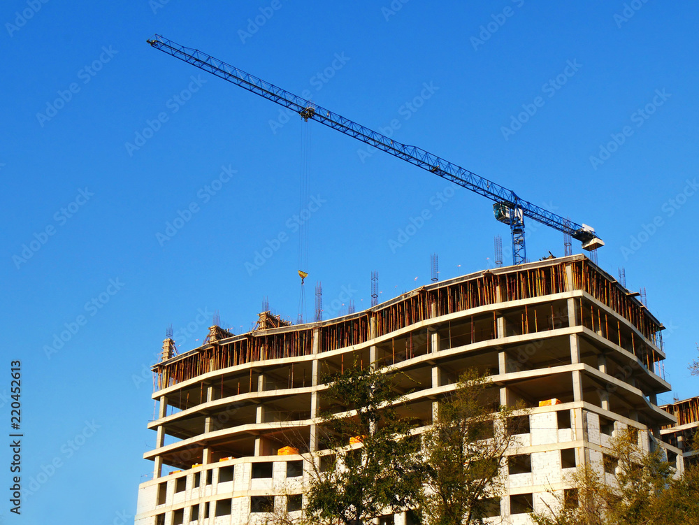 Construction site background. Huge crane near building.
