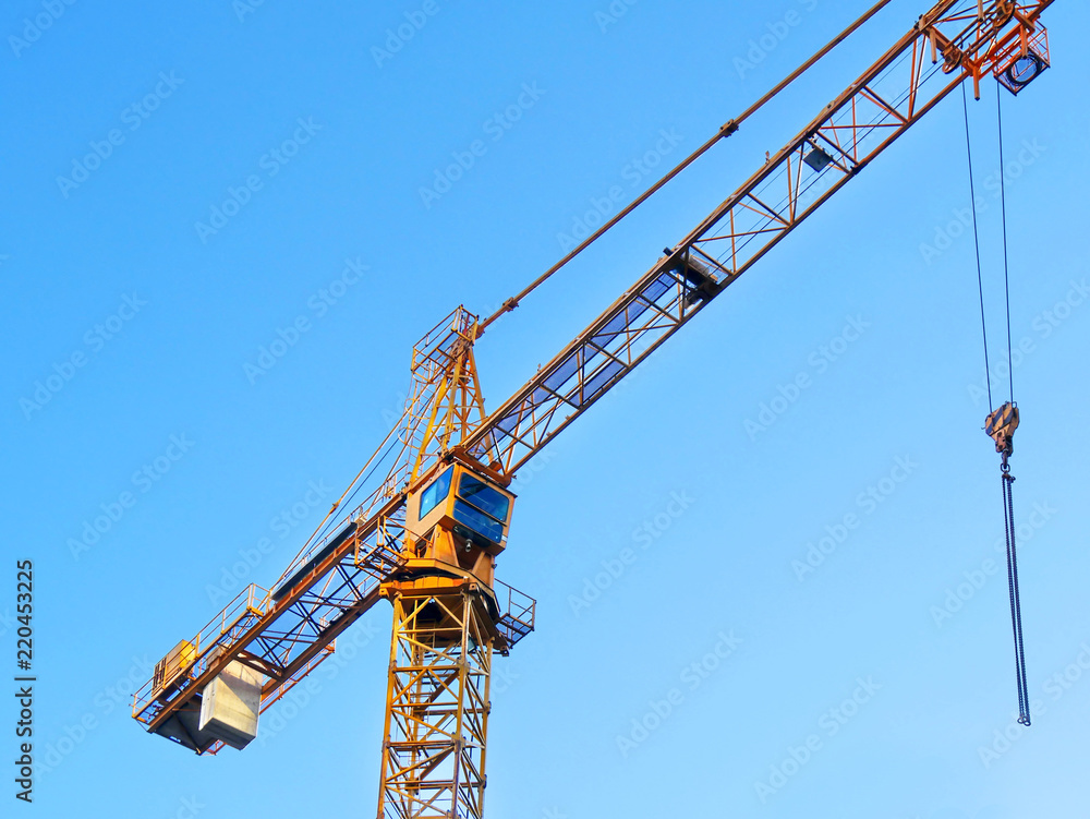 Self-erection crane against blue sky. Self-erection crane against blue sky.