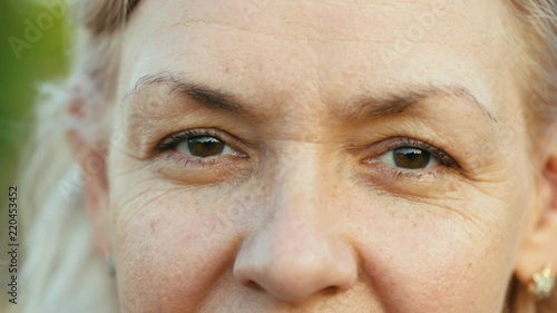 Extreme close up of Caucasian woman's eyes Middle aged white lookingcamera slow motion wisdom humanity photo