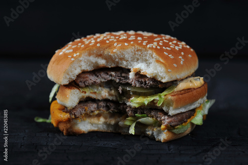 bitten burger on a dark rustic