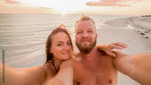 LOVERS KEY, FORT MYERS BEACH, FLOIRDA/USA 11/4/15: Young couple enjoying the sunset on the beach. © ryan