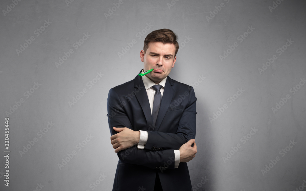 Young tired businessman with thermometer and copy space
Young tired businessman with thermometer and copy space