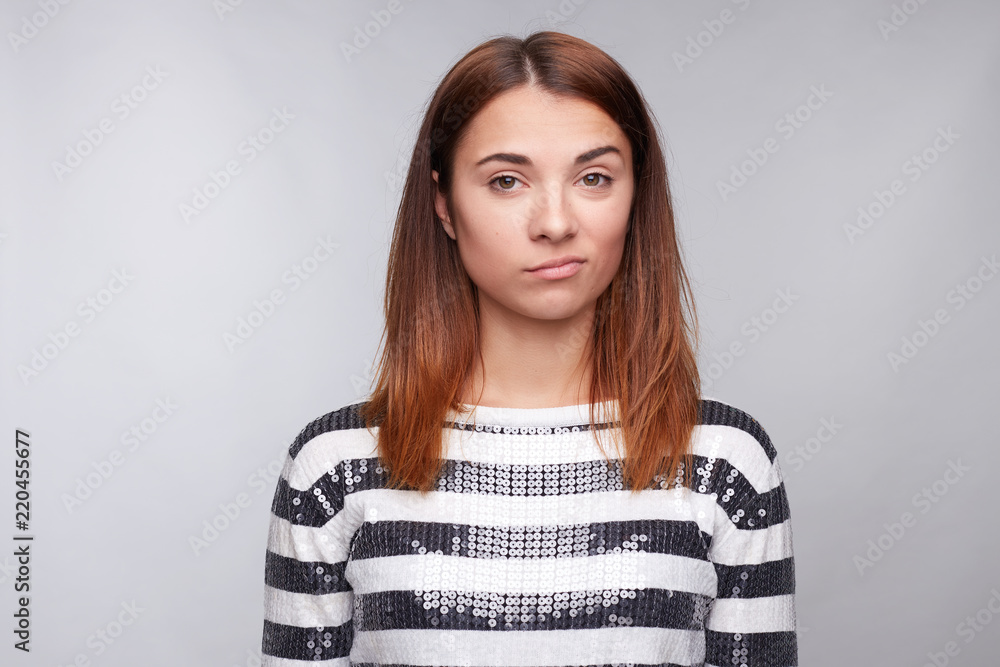 What the hell are you talking about, nonsense. Studio shot of frustrated female with red hair, frowning, being displeased and confused with dumb question, isolated over gray studio wall wth copy space What the hell are you talking about, nonsense. Studio shot of frustrated female with red hair, frowning, being displeased and confused with dumb question, isolated over gray studio wall wth copy space