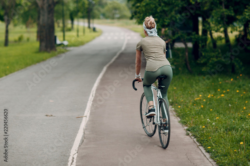 Young woman riding bike © primipil