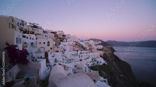 Sunset over beautiful town of Oia on the Island of Santorini.