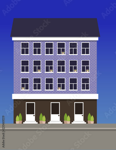 A multi-storey dwelling house made of blue bricks.