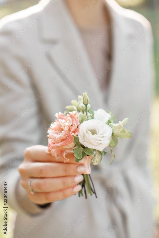boutonniere. Young girl holding a beautiful spring Flowers. flower arrangement with lisianthus. Color light pink. Bright dawn or sunset sun boutonniere. Young girl holding a beautiful spring Flowers. flower arrangement with lisianthus. Color light pink. Bright dawn or sunset sun