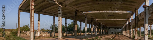 A deserted industrial plant site with old deserted structure on a beautiful sunset.