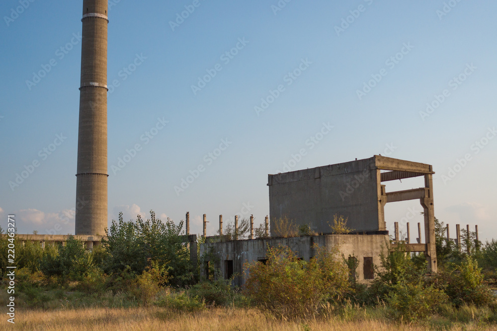 A deserted industrial plant site with big towers on a beautiful sunset. A deserted industrial plant site with big towers on a beautiful sunset.
