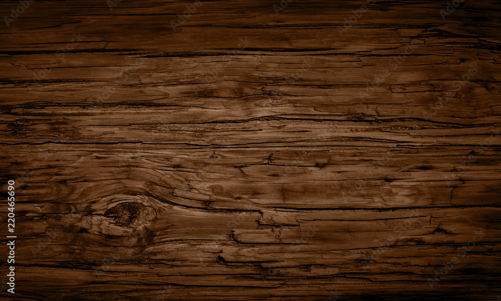Dark stained brown reclaimed wood surface with aged boards lined up