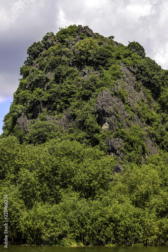 Clouds Forming behind a Bamboo Covered Limestone Cliff at the Perfume Pagoda in Vietnam