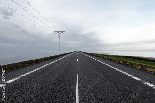 Long straight causeway with power line in Denmark © Ansgar Hiller