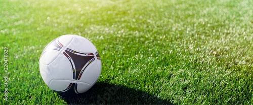 Close view of green football field with soccer ball