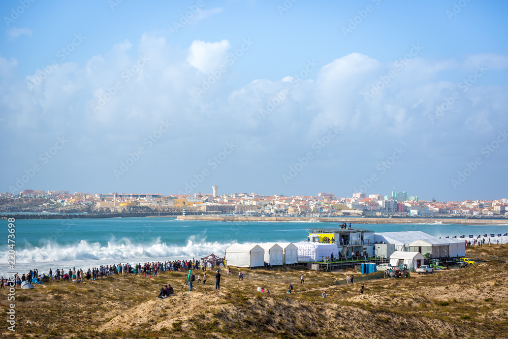 Peniche, Portugal - Oct 18th 2017 - Big crowd of people watching a big wave breaking at the 2017 MEO Rip Curl Pro Portugal in Peniche, coast of Portugal.