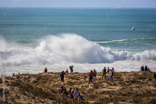 Peniche, Portugal - Oct 18th 2017 - Big crowd of people watching a big wave breaking at the 2017 MEO Rip Curl Pro Portugal in Peniche, coast of Portugal. photo