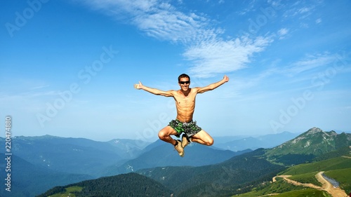 Man is flying on beautiful backgroung of mountains, Krasnaya Polyana