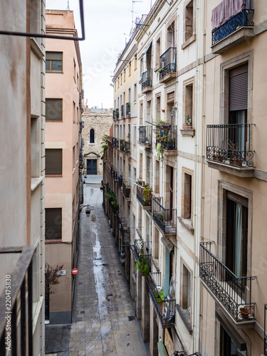 Narrow city street with wrought iron balconies in old town near gothic quarter, Barcelona, Spain on an overcast day © Jennifer Jean