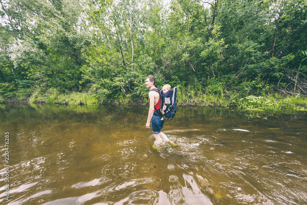 The daddy carries the child during a flood in the jungle. The daddy carries the child during a flood in the jungle.