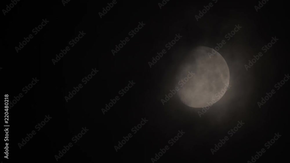 Moon behind clouds at night Moon behind clouds at night