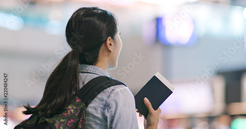 Photography Woman checking the flight number in the airport