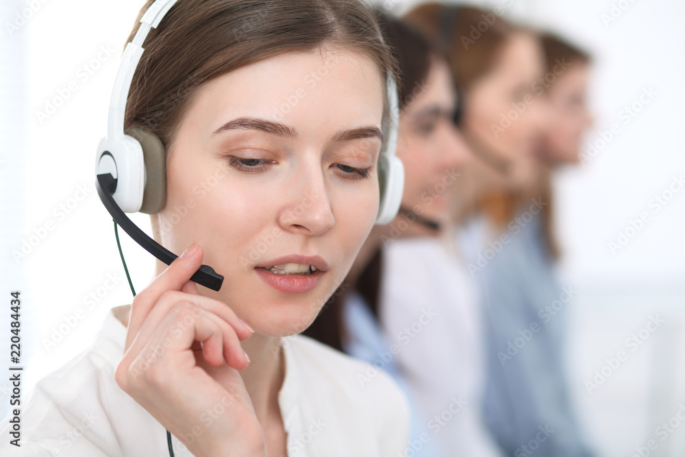 Call center. Beautiful cheerful smiling operator consulting clients with headset. Business concept of customer service