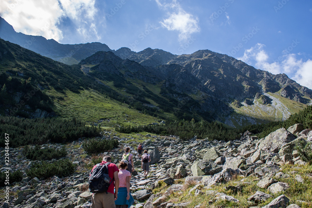 Young man hiking into the mountains