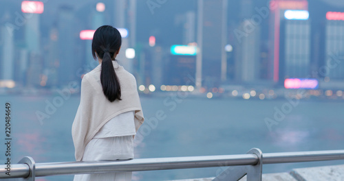 Photography Woman look far away of the city view in Hong Kong