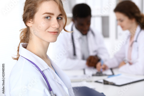 Happy doctor woman with medical staff at the hospital