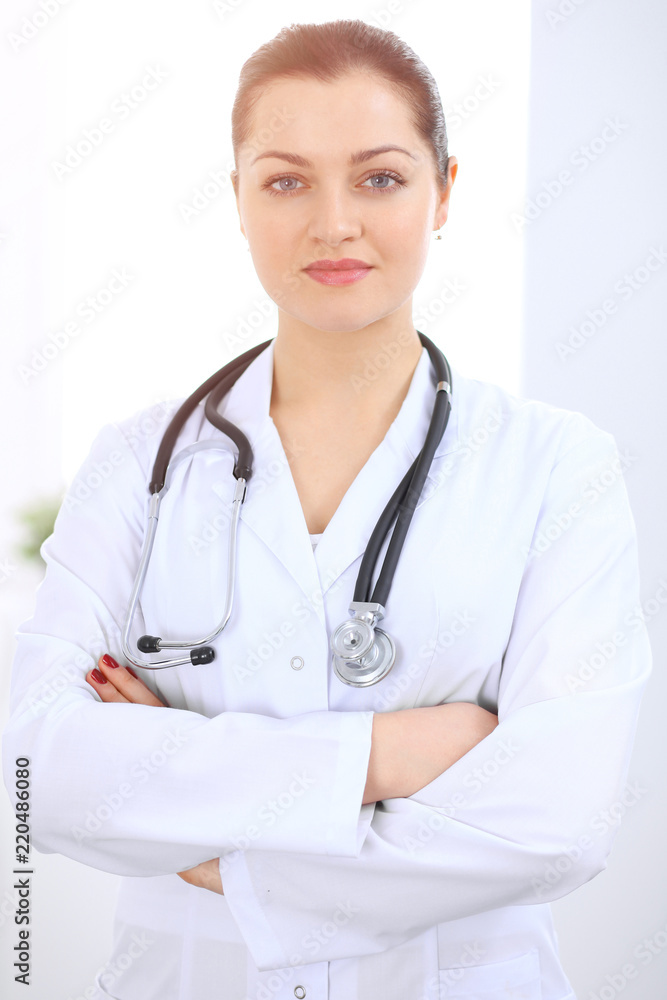 Brunette female doctor standing straight at hospital. Medicine and health care concept Brunette female doctor standing straight at hospital. Medicine and health care concept