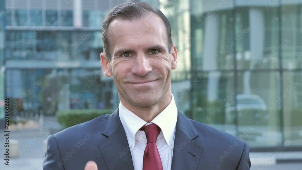 Thumbs Up by Middle Aged Businessman Outside Office Thumbs Up by Middle Aged Businessman Outside Office