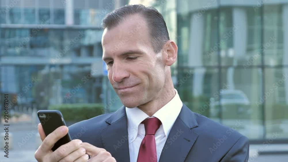 Middle Aged Businessman Using Smartphone for Browsing online Middle Aged Businessman Using Smartphone for Browsing online
