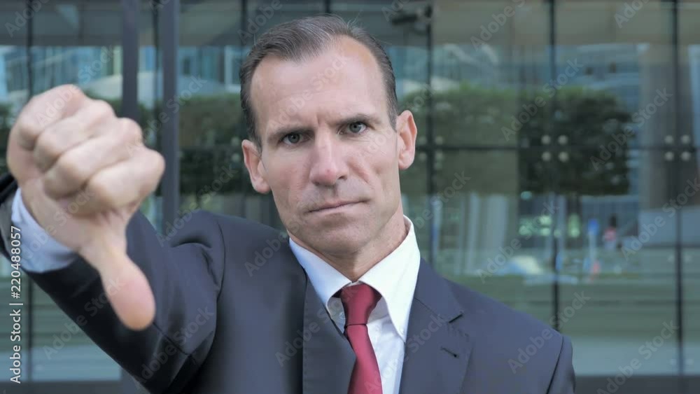 Thumbs Down by Middle Aged Businessman Thumbs Down by Middle Aged Businessman