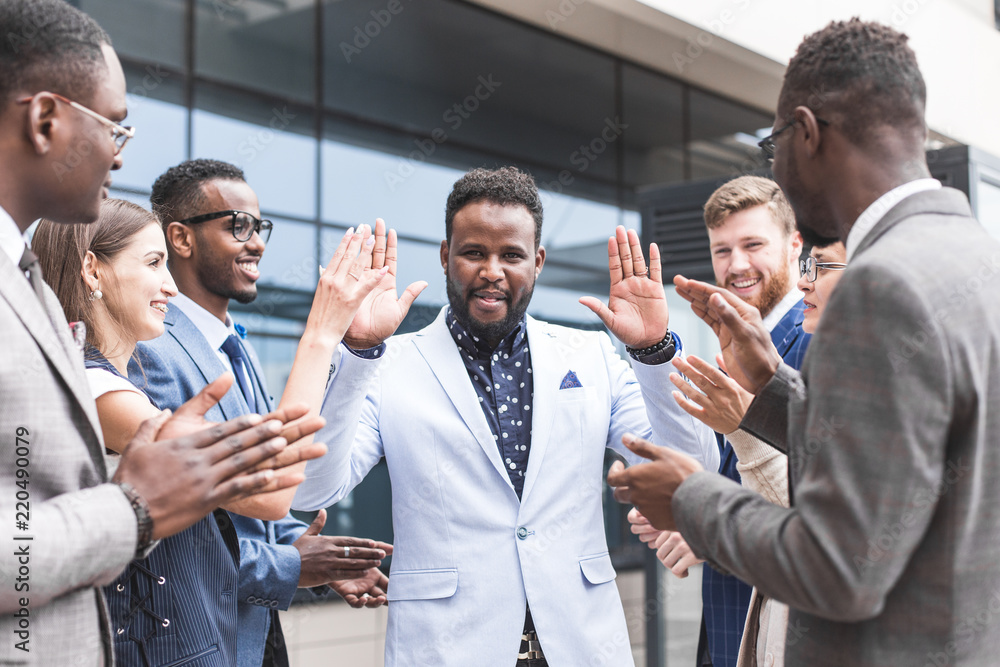 Obraz premium Portrait of an handsome businessman in front of his team. recognition, movement on the career ladder, success in business
