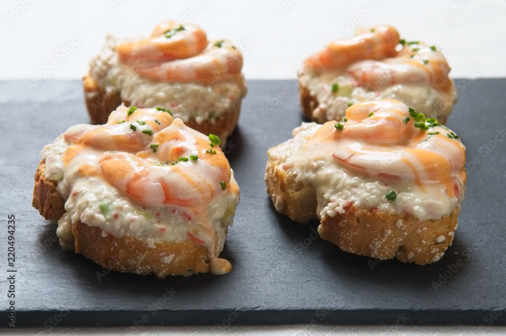 skewer of prawns with spanish potato salad