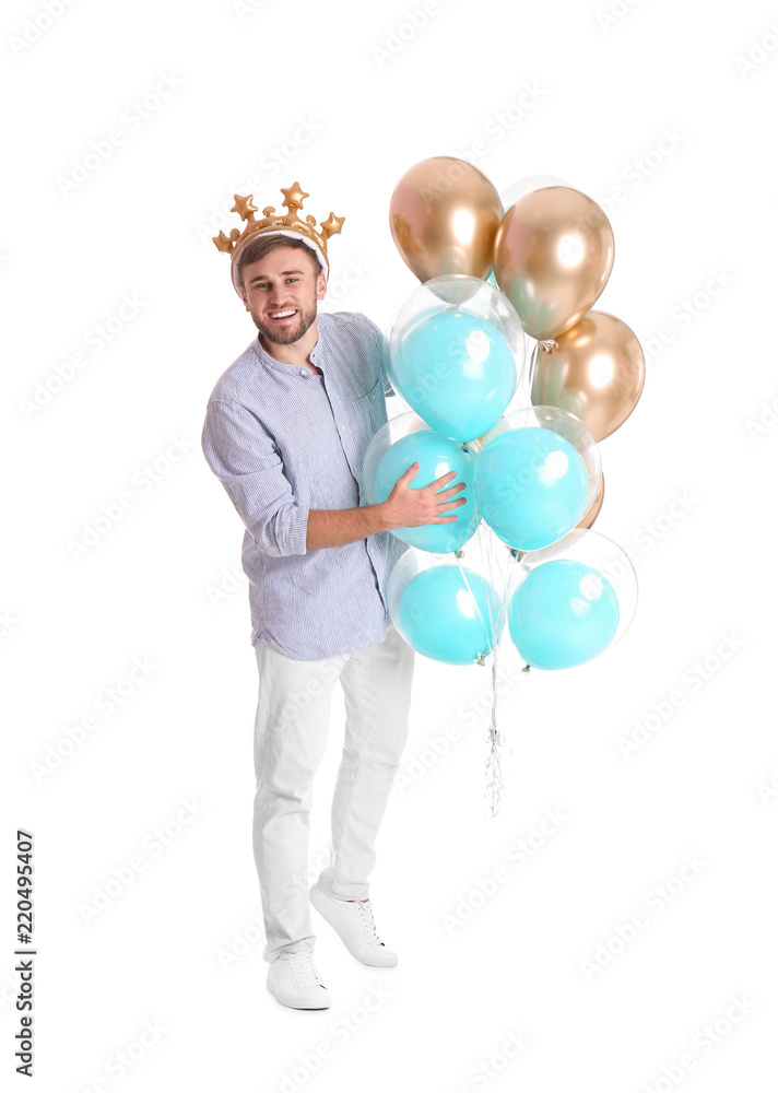 Young man with crown and air balloons on white background Young man with crown and air balloons on white background