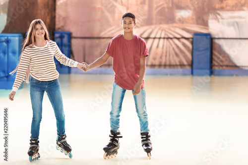 Cute teenage couple at roll...